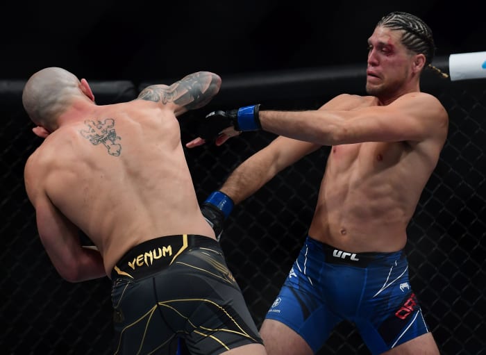 Brian Ortega defends against Alexander Volkanovski during UFC 266 at T-Mobile Arena.